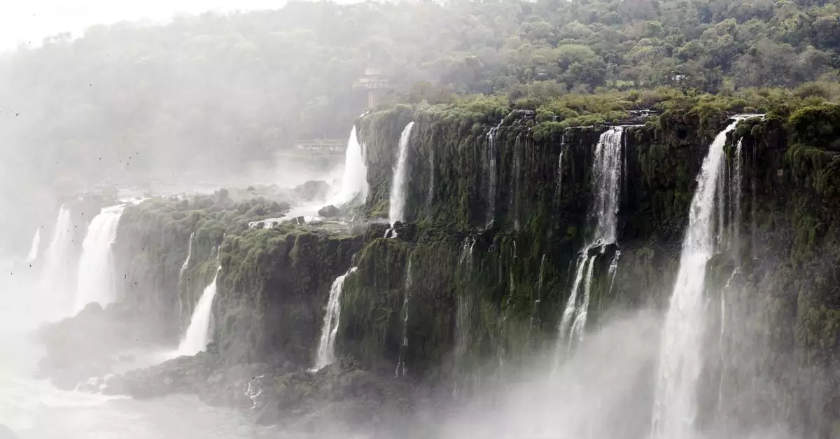 Stunning view of Iguaz&uacute; Falls cascading amidst lush greenery in Argentina.
