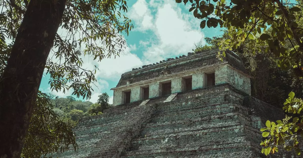 Explore the majestic ancient Mayan ruins surrounded by a dense Mexican jungle, showcasing historical architecture and natural beauty.