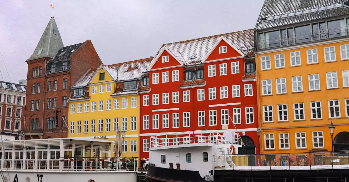Vibrant facade of Nyhavn's historic waterfront buildings by the canal in Copenhagen.