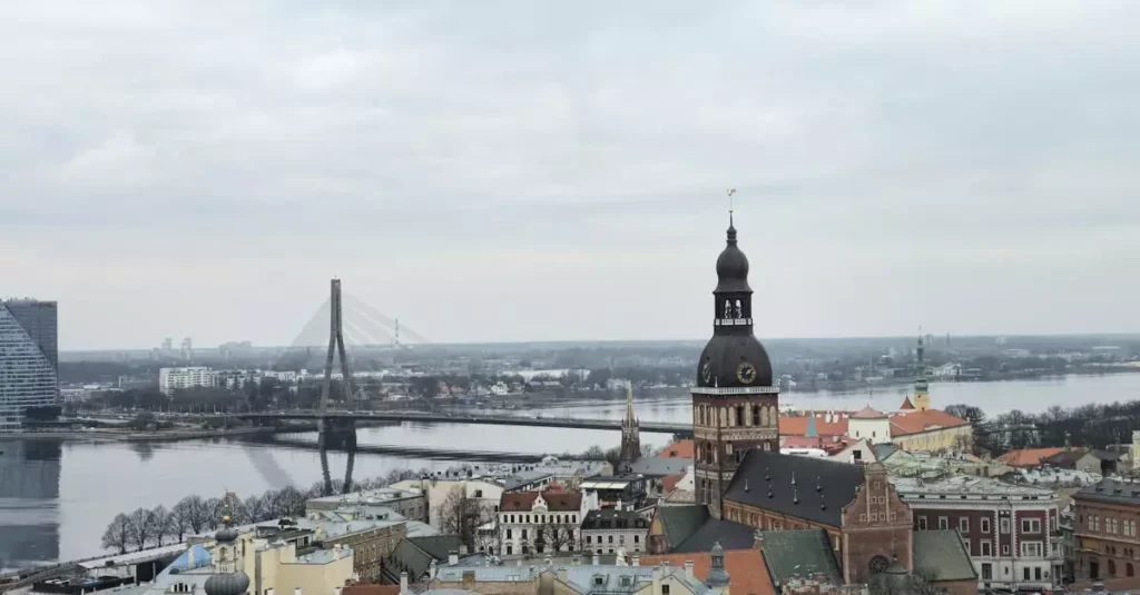 Best Northern Europe Destinations for Adventure 2 Aerial view of Riga featuring St. Peter's Church and Vanšu Bridge over the Daugava River.