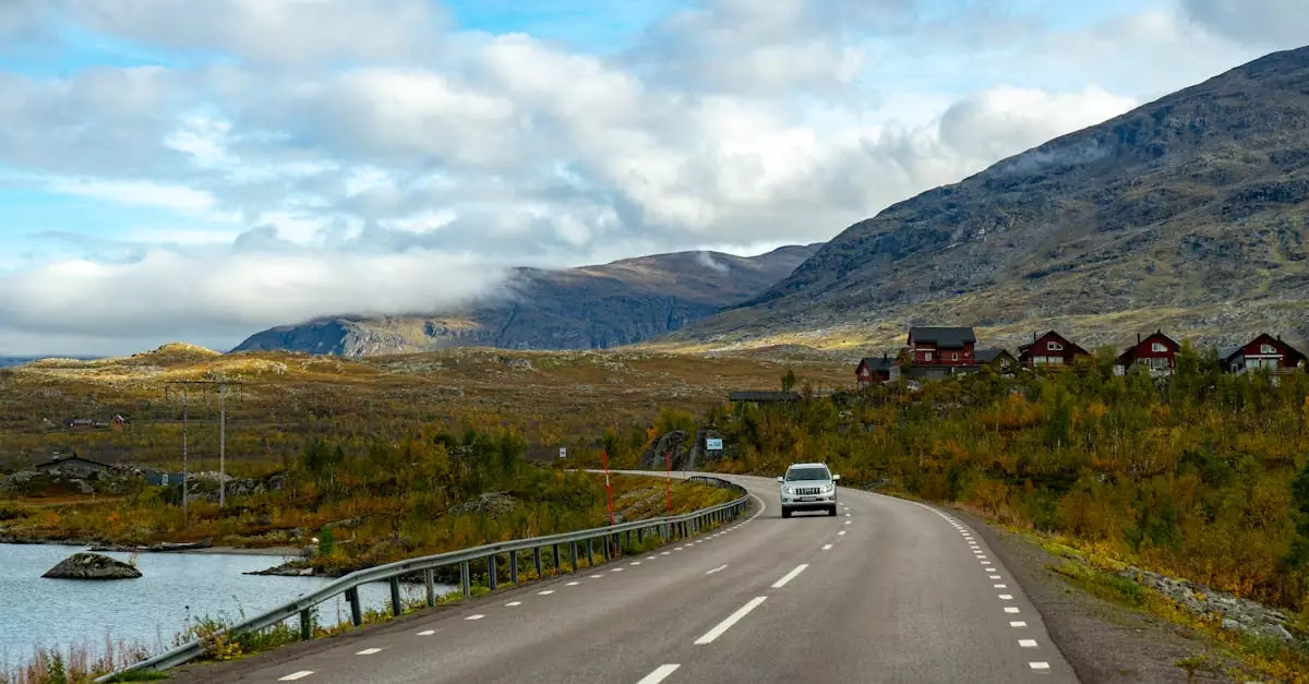 Explore the picturesque road through Kiruna, Sweden, surrounded by mountains and autumn colors.