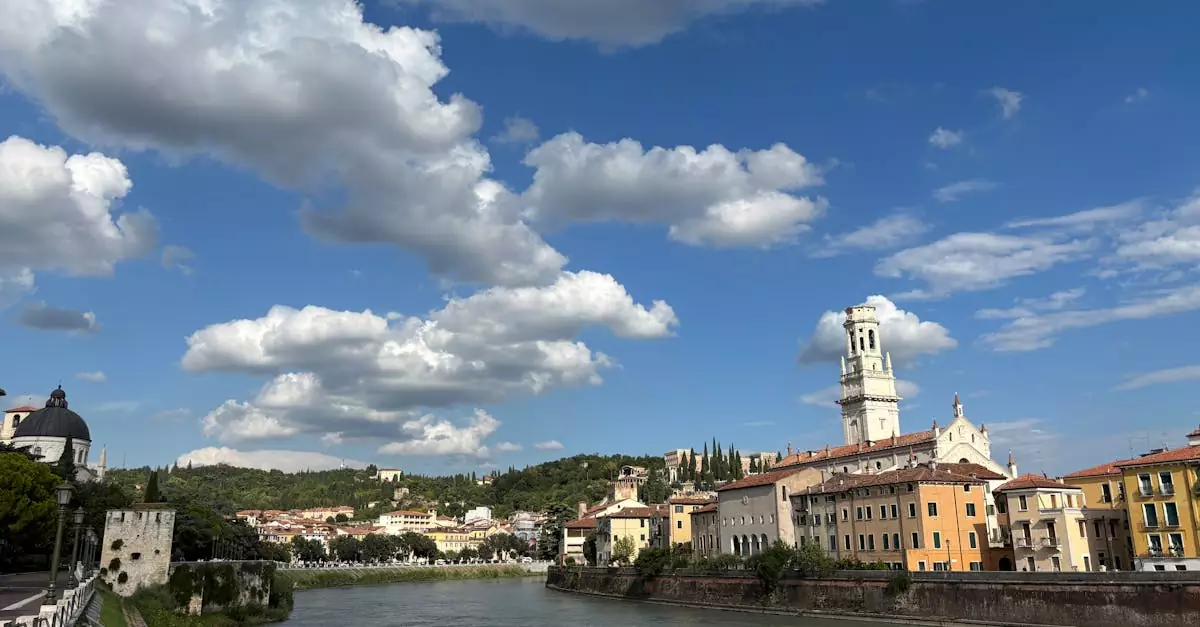 A beautiful day in Verona, Italy with vibrant sky and historic architecture by the river.