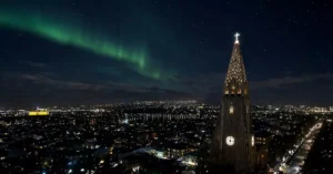 Breathtaking view of the Northern Lights over Hallgrímskirkja in Reykjavik, Iceland.