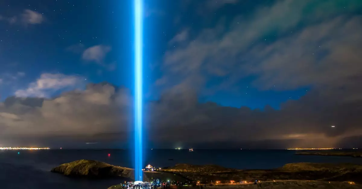A stunning light beam from the Imagine Peace Tower in Reykjavik, Iceland against a starry night sky.