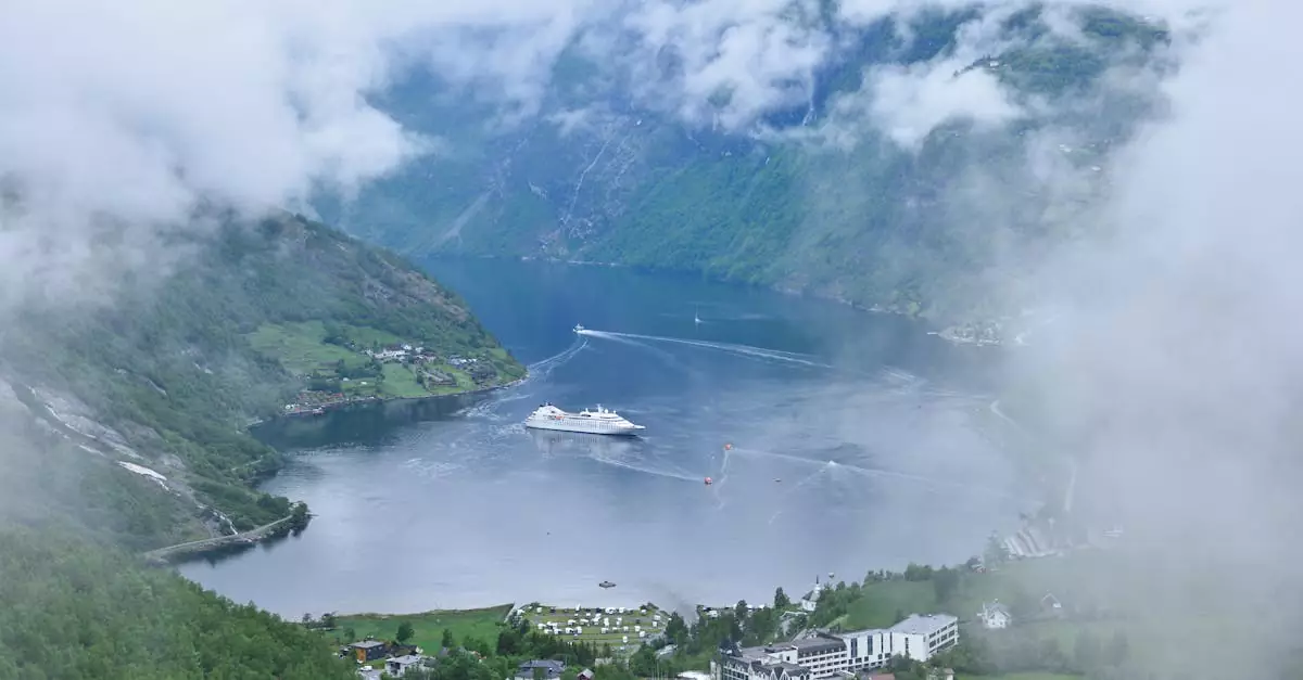 Breathtaking aerial view of Geiranger Fjord in Norway with a cruise ship and lush scenery.
