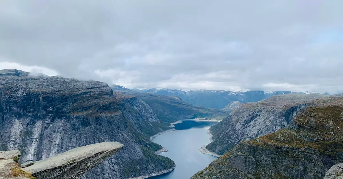 Stunning aerial view of the iconic Trolltunga rock formation in Ullensvang, Vestland, overlooking a serene fjord in Norway.