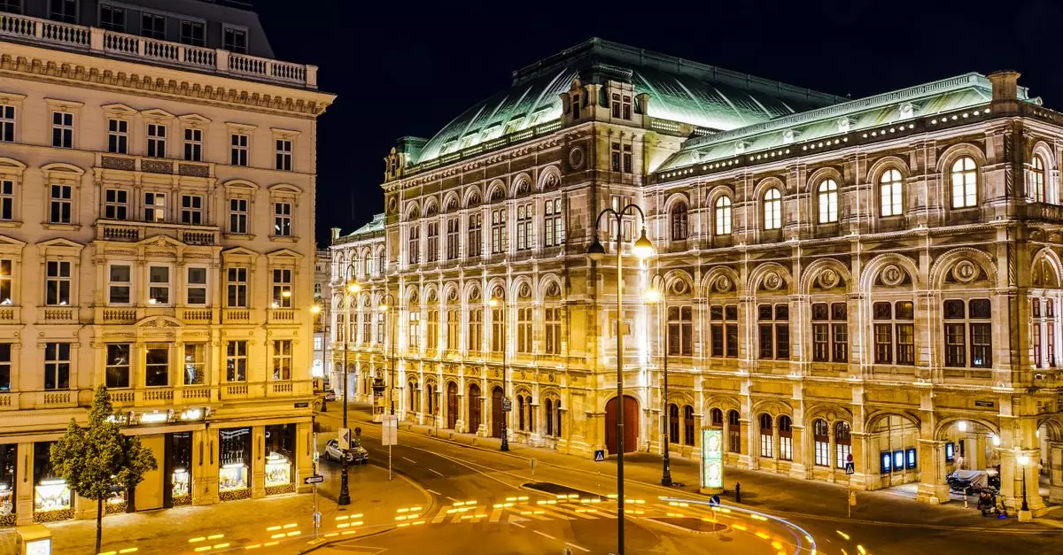 Illuminated Vienna State Opera at night, showcasing urban architecture and street lights.