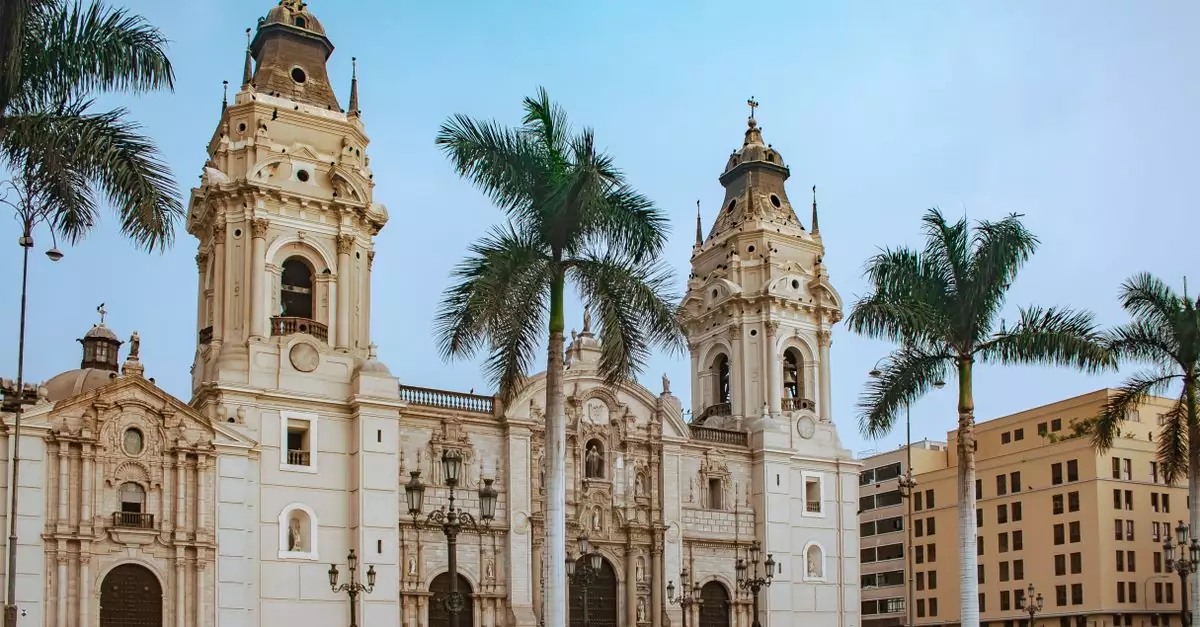 Stunning view of Lima Cathedral with palm trees in vibrant Plaza Mayor, Peru.