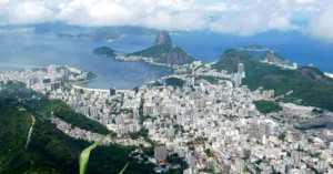 Breathtaking aerial view of Rio de Janeiro, highlighting Sugarloaf Mountain and lush landscapes.