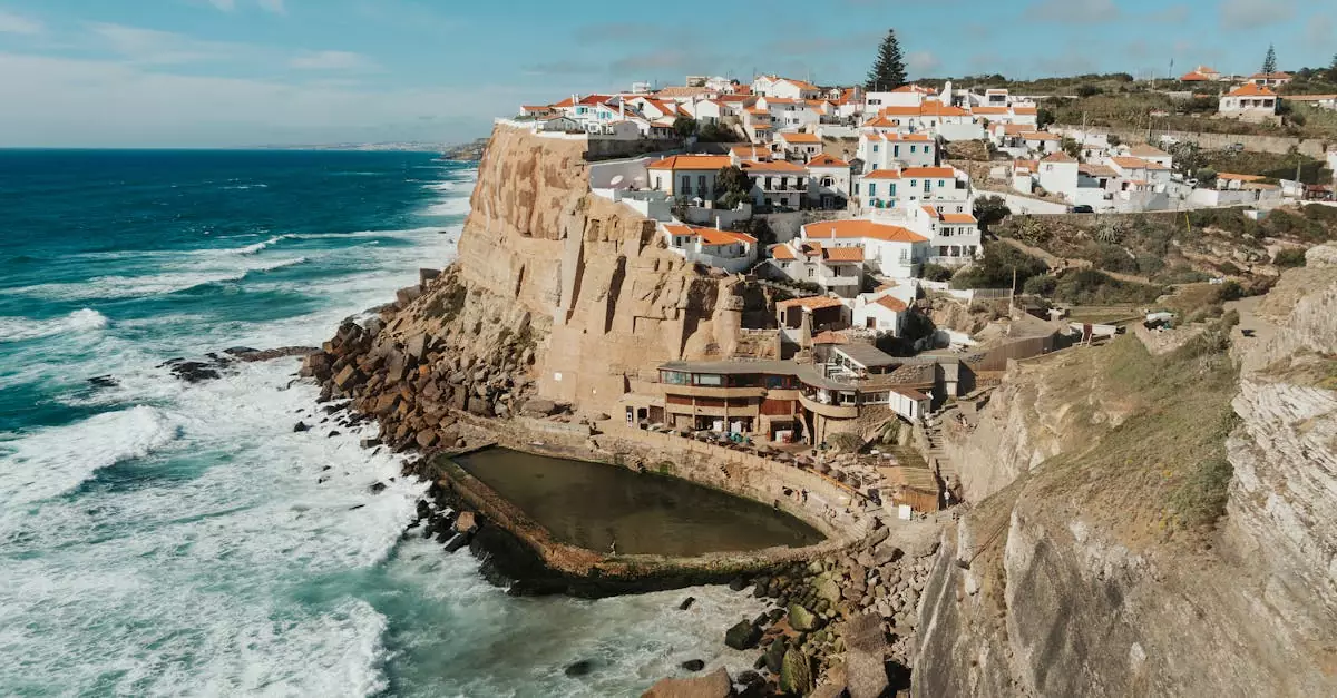 Scenic coastal view of Azenhas do Mar village, Portugal, perched on dramatic cliffs by the Atlantic Ocean.