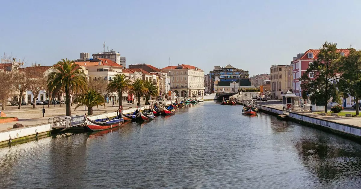 Charming view of Aveiro's central canal with colorful moliceiros and classic architecture along the waterfront.