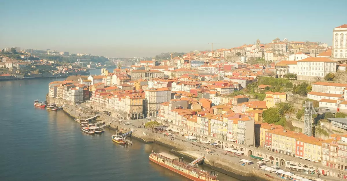 Breathtaking aerial view of Ribeira district along Douro River in Porto, Portugal with colorful architecture.