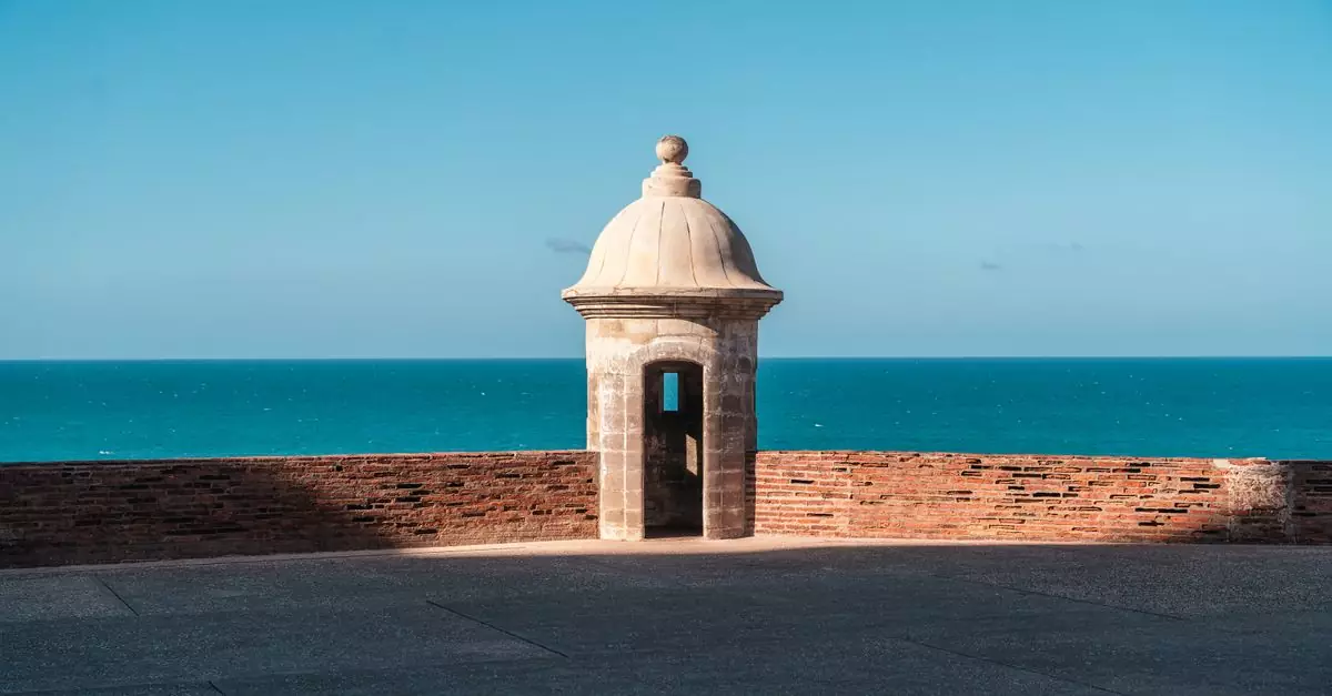 Historic guard tower with ocean view, showcasing a blend of architecture and nature.