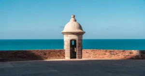 Historic guard tower with ocean view, showcasing a blend of architecture and nature.