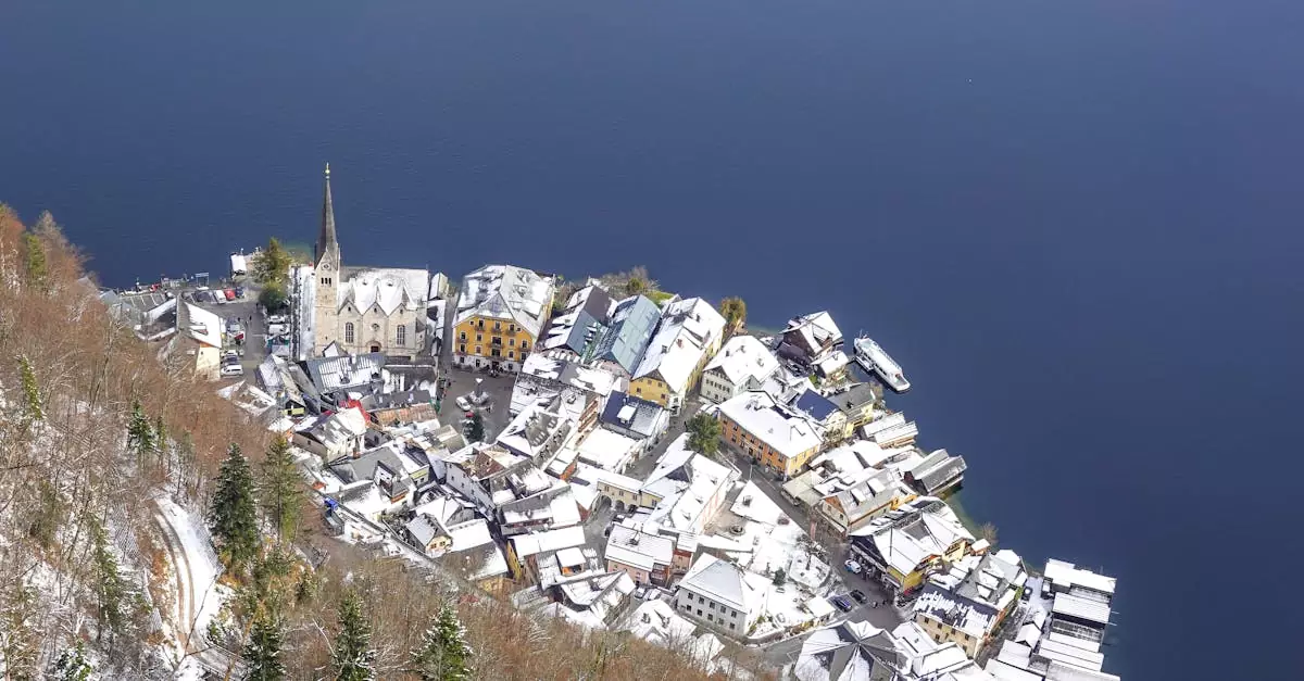 Stunning aerial view of snow-covered Hallstatt village overlooking the serene lake in winter.