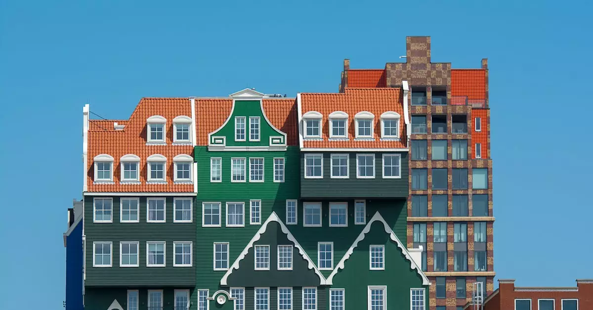 Vibrant facade of Inntel Hotels in Zaandam, featuring colorful, traditional Dutch architecture under a clear blue sky.