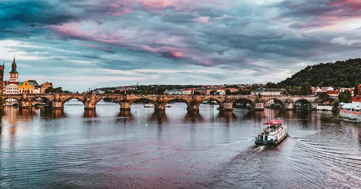Stunning view of Charles Bridge with vibrant sunset hues over Vltava River in Prague.