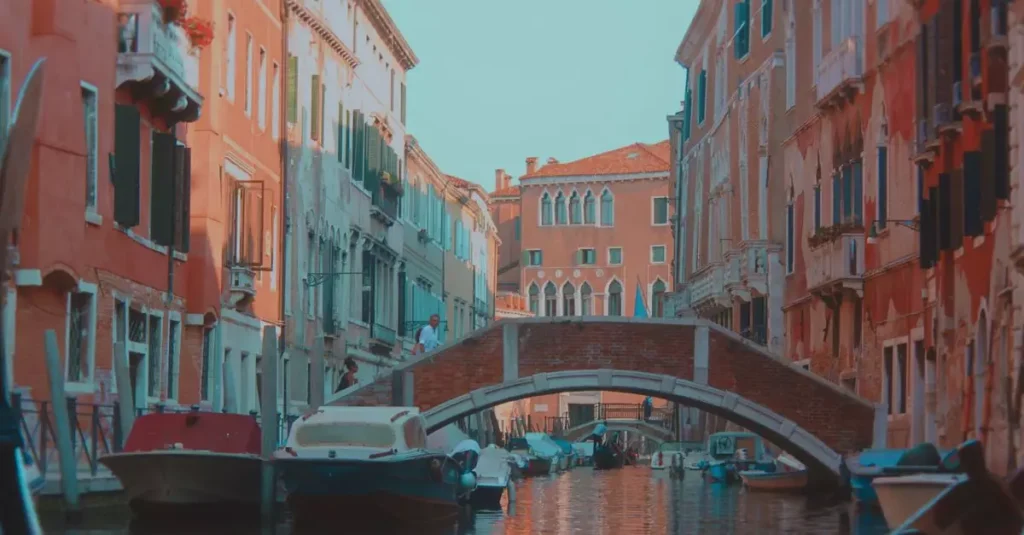 Scenic view of a Venetian canal with historic buildings and a footbridge, perfect for travel inspiration.