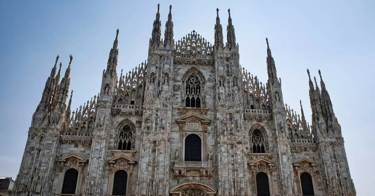 Majestic view of Milan Cathedral showcasing its intricate Gothic design under a clear sky.