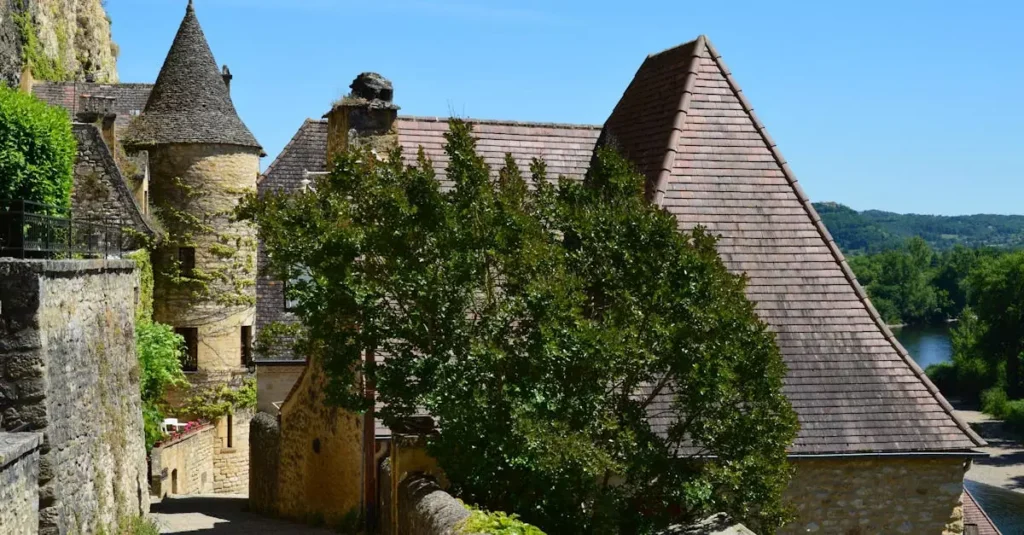 Explore a picturesque medieval castle with stone towers and lush greenery on a sunny day.