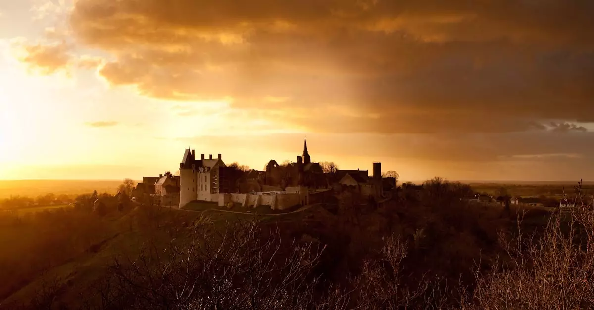 Breathtaking sunset casting a warm glow over Sainte-Suzanne Castle in Pays de la Loire, France.