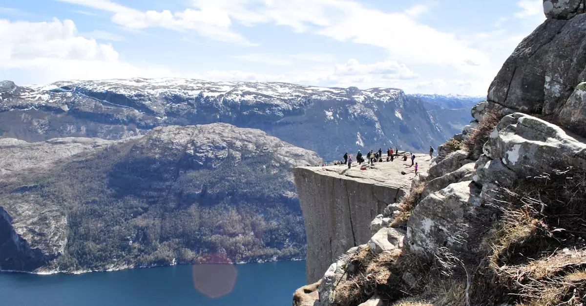 Tourists enjoy the breathtaking view from the famous Preikestolen cliff in Norway.