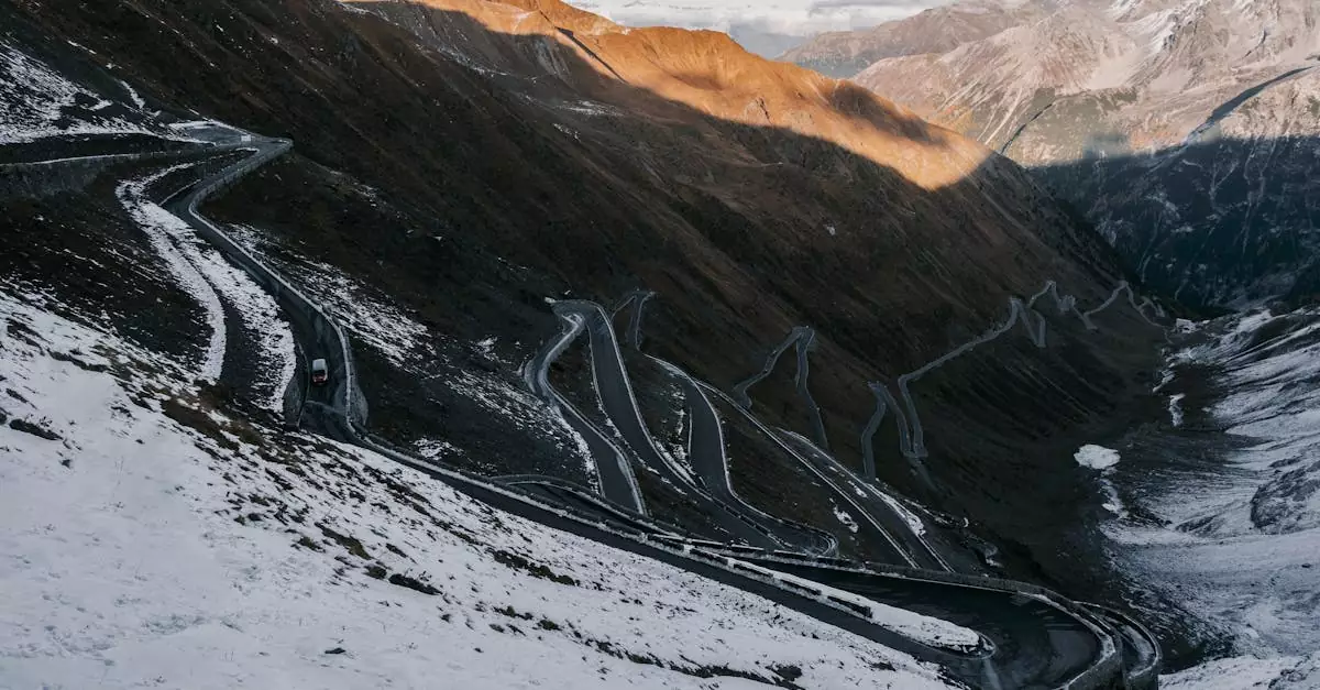 Scenic winter view of Stelvio Pass winding through snow-covered mountains in the Italian Alps.