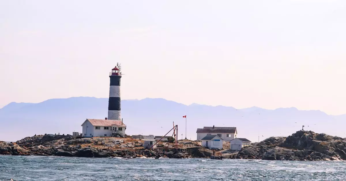 Scenic view of a lighthouse on rocky coast in British Columbia, Canada.