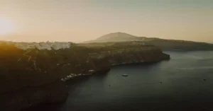 Capture of Thera's dramatic cliffs in Santorini, Greece, at sunset. A tranquil sea view.