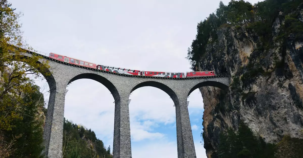 Stunning view of red train crossing the iconic Landwasser Viaduct in the Swiss Alps.