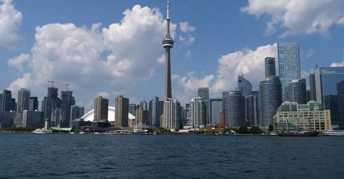 Stunning view of Toronto skyline with CN Tower and Lake Ontario on a sunny day.