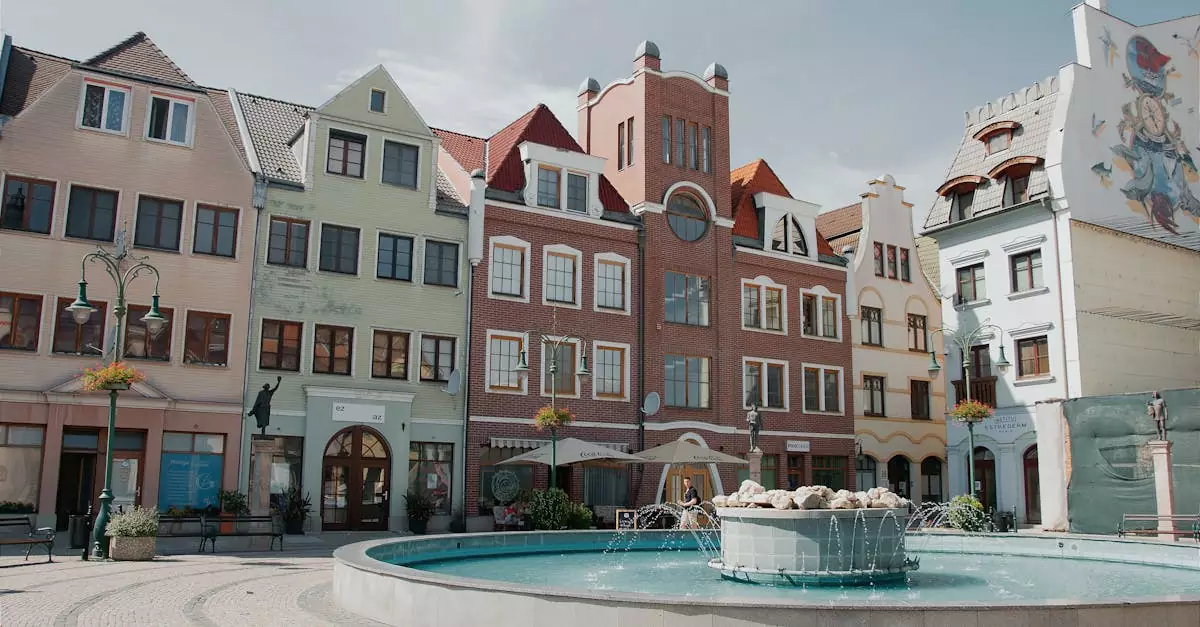 A vibrant square in Komárno featuring colorful facades and a central fountain.
