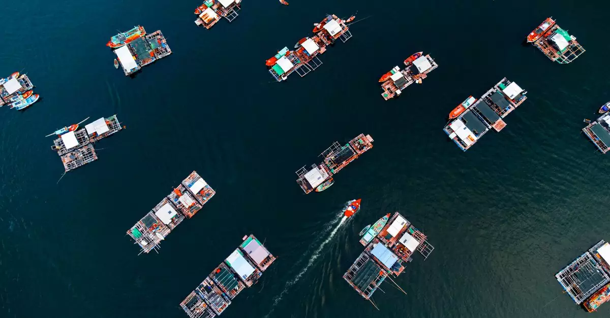 Aerial shot of floating fishing village in blue ocean, Kiên Giang, Vietnam.