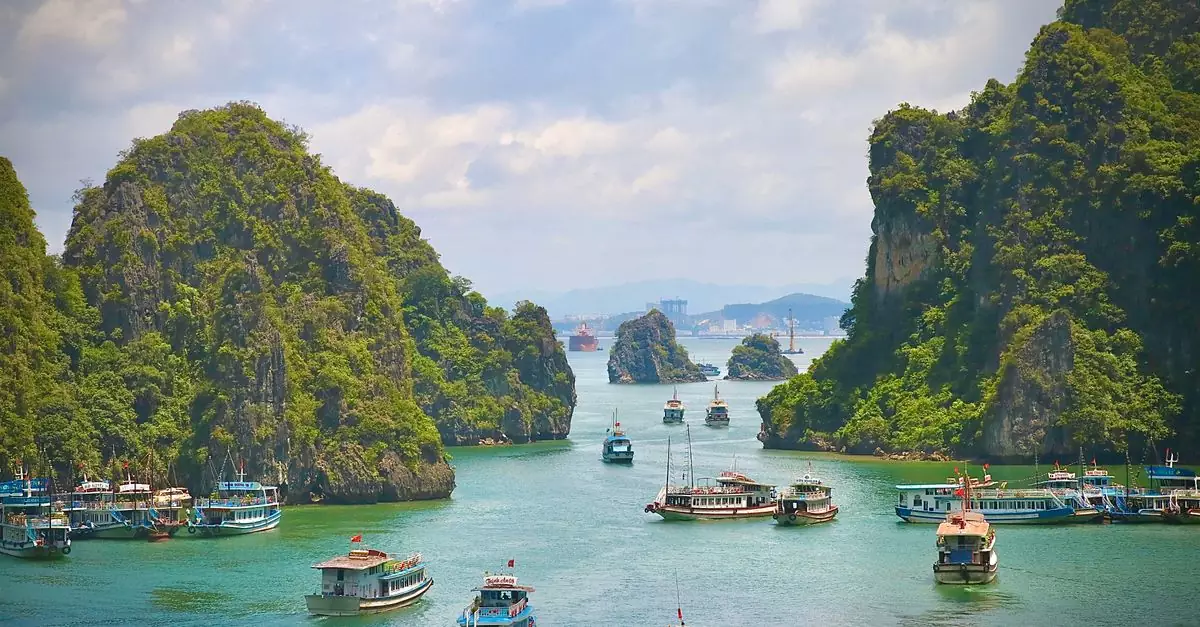 Explore the stunning landscape of Halong Bay with numerous boats sailing through emerald waters.