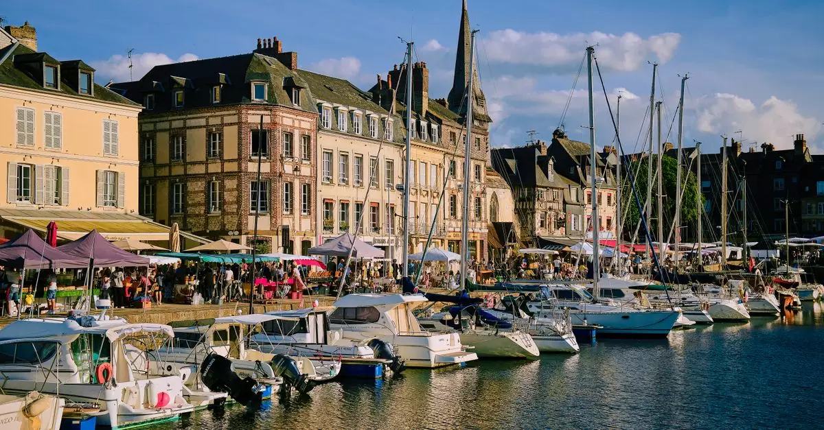 A picturesque view of Honfleur Marina in Normandy, France with boats and historic architecture.