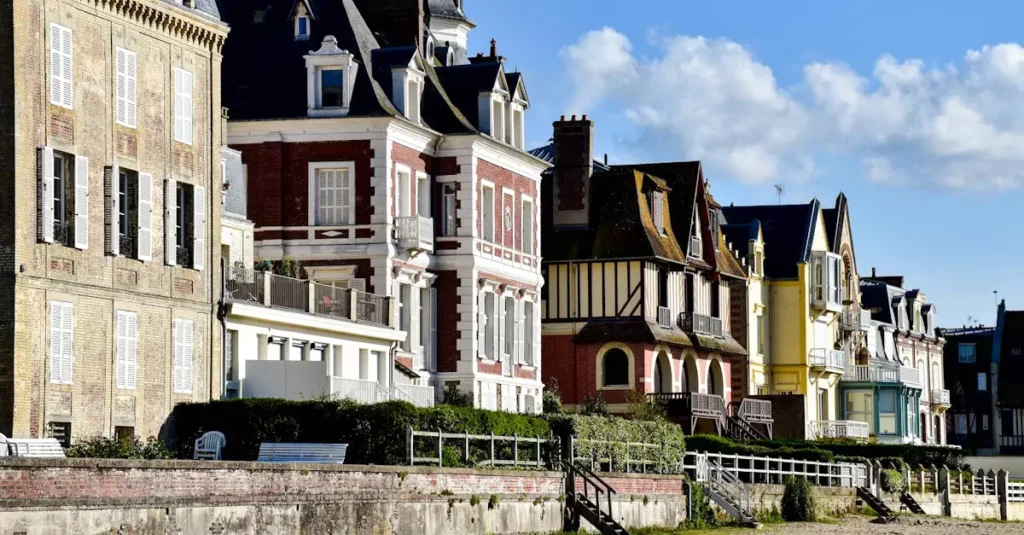 Best Seaside Towns France: Coastal Charms Guide 4 Explore picturesque beachfront architecture in Deauville, France, with vibrant homes by the sea.