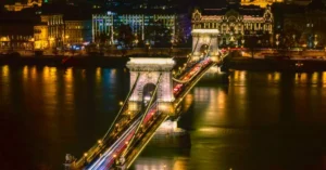 Stunning long exposure night shot of the Széchenyi Chain Bridge, showcasing illuminated architecture and city lights in Budapest.