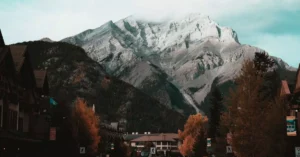 Picturesque Banff, Canada with mountains and autumn trees lining the road.
