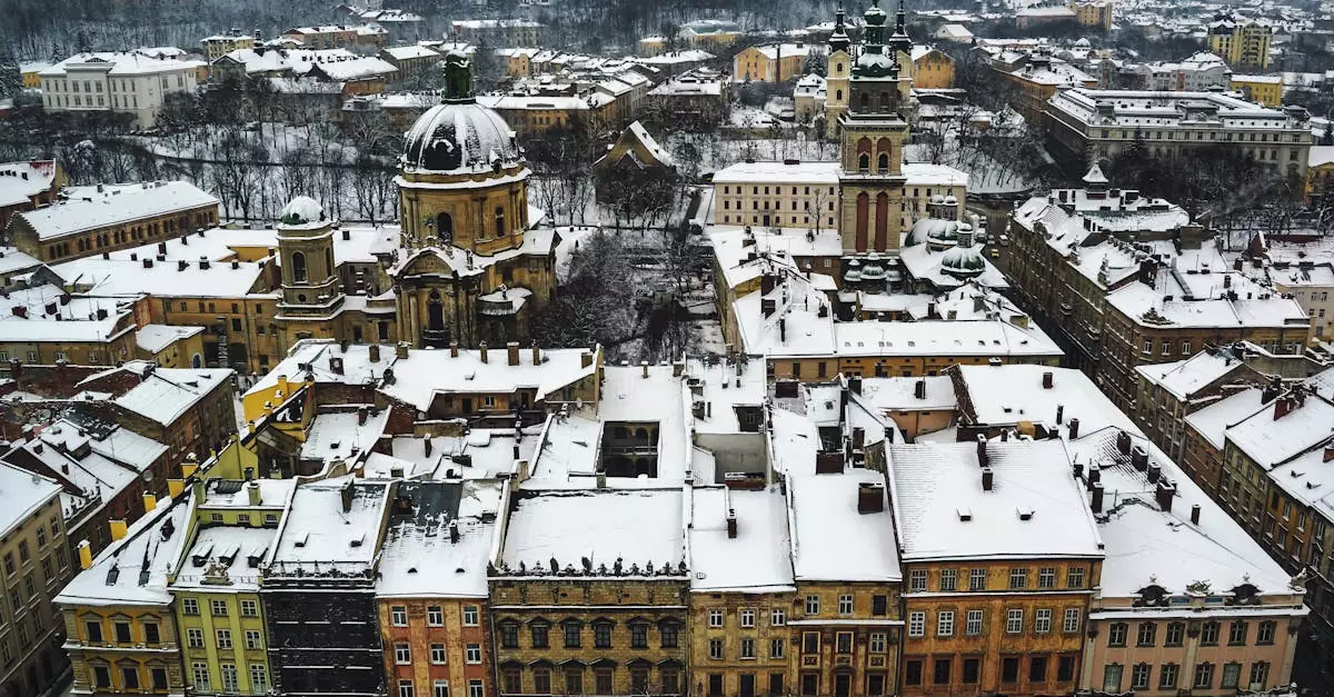 Aerial shot of Lviv's historic city center with snow-covered rooftops in winter.
