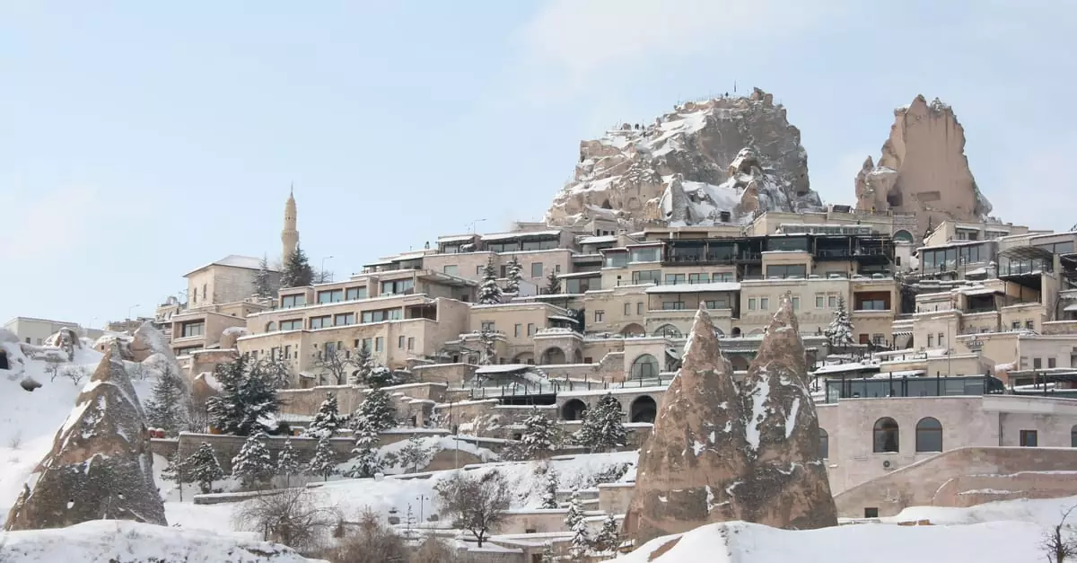 A serene view of a snow-covered town in Cappadocia, Turkey.