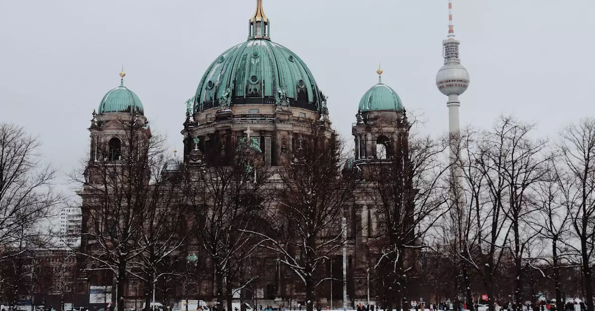 Snow-covered Berlin Cathedral and TV Tower with people walking around.