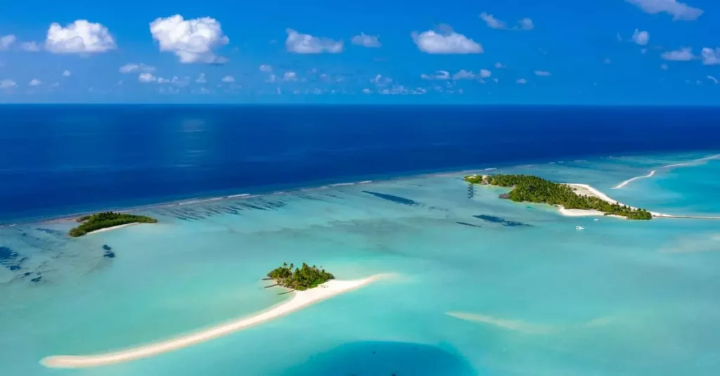 Best Summer Island Escapes: Your Dream Getaway Guide 2 Aerial view of serene tropical islands with azure waters in the Maldives.