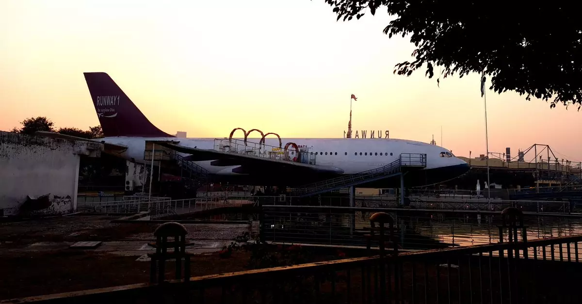 Aerial-themed exhibit with airplane at sunset in Delhi, India. Ideal for travel-themed presentations.
