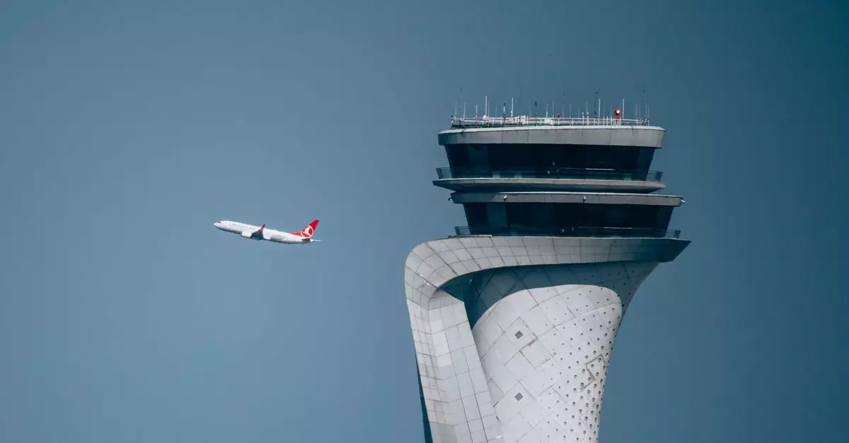 Turkish Airlines plane soaring past İstanbul's iconic airport control tower in clear blue skies.