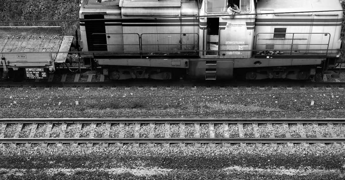 Vintage locomotive on tracks at Brennero station, Italy, in black and white.