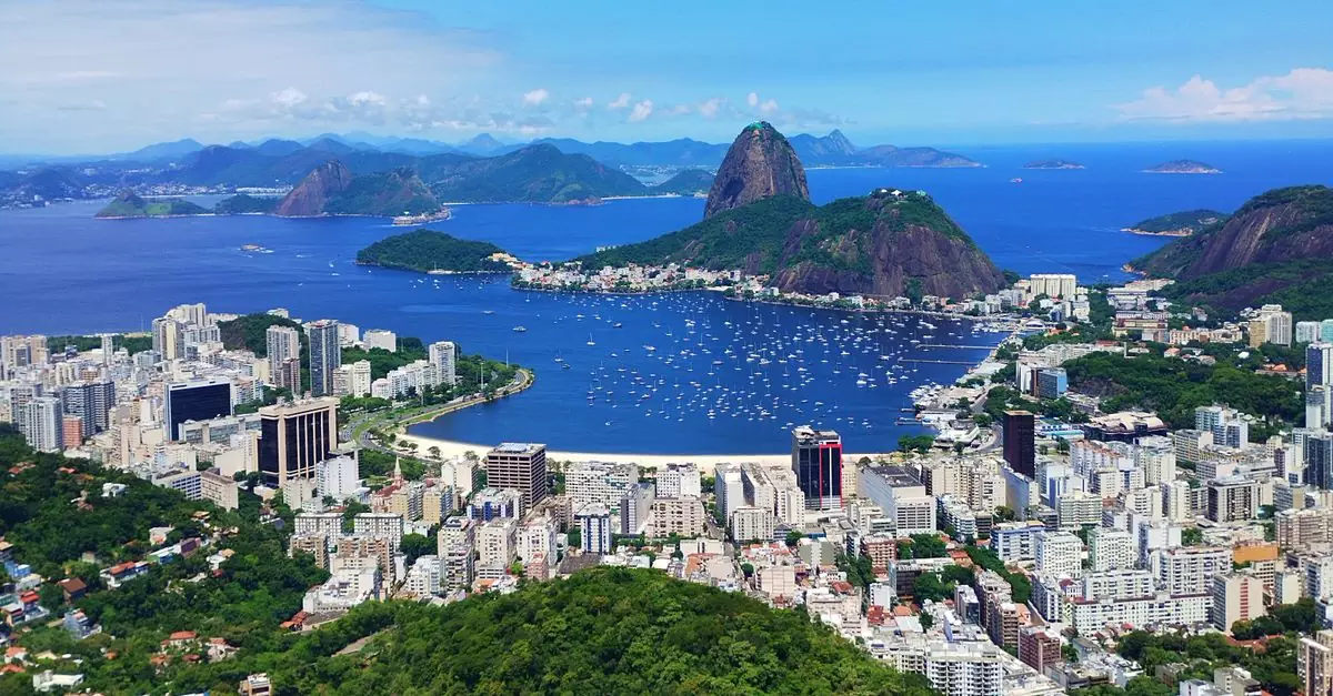 A breathtaking aerial view of Rio de Janeiro's coast showcasing Sugarloaf Mountain and vibrant cityscape.