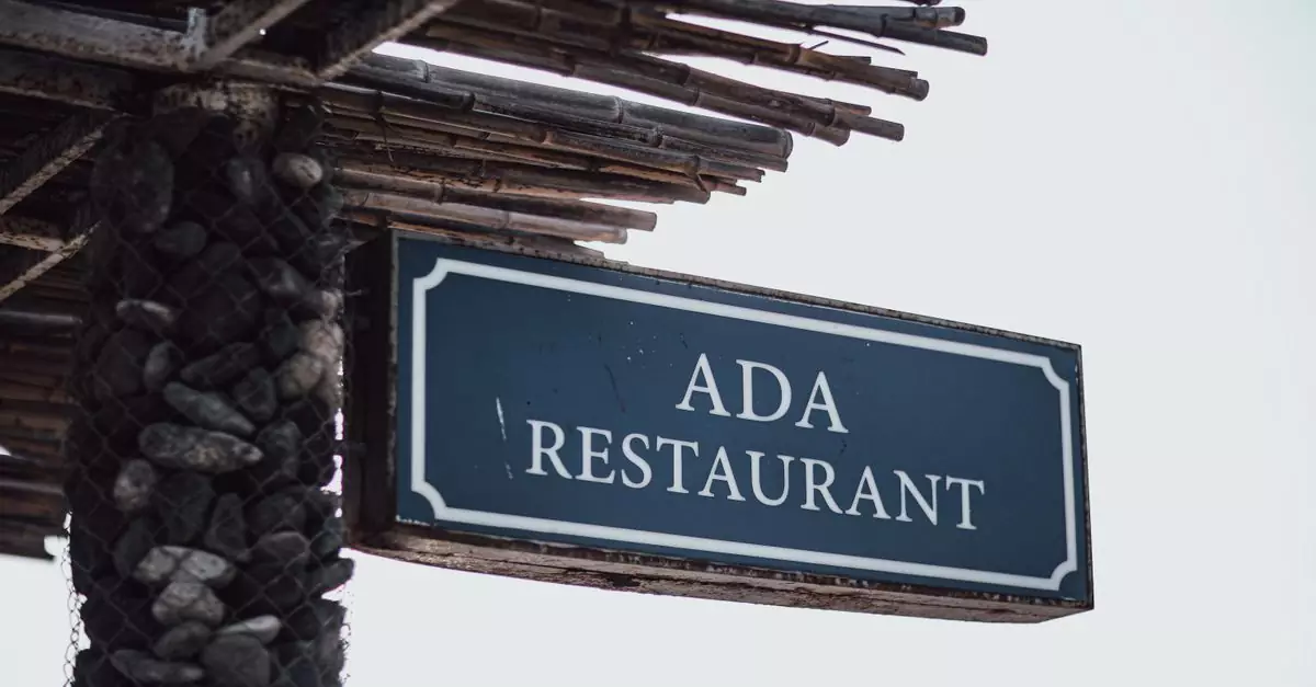 Outdoor sign of Ada Restaurant under a rustic wooden awning in Baku.