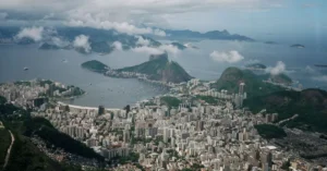 Aerial shot of Rio de Janeiro's skyline featuring Sugarloaf Mountain and Guanabara Bay.