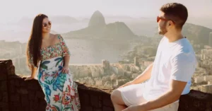 A happy couple enjoying the panoramic view of Rio de Janeiro's iconic skyline.