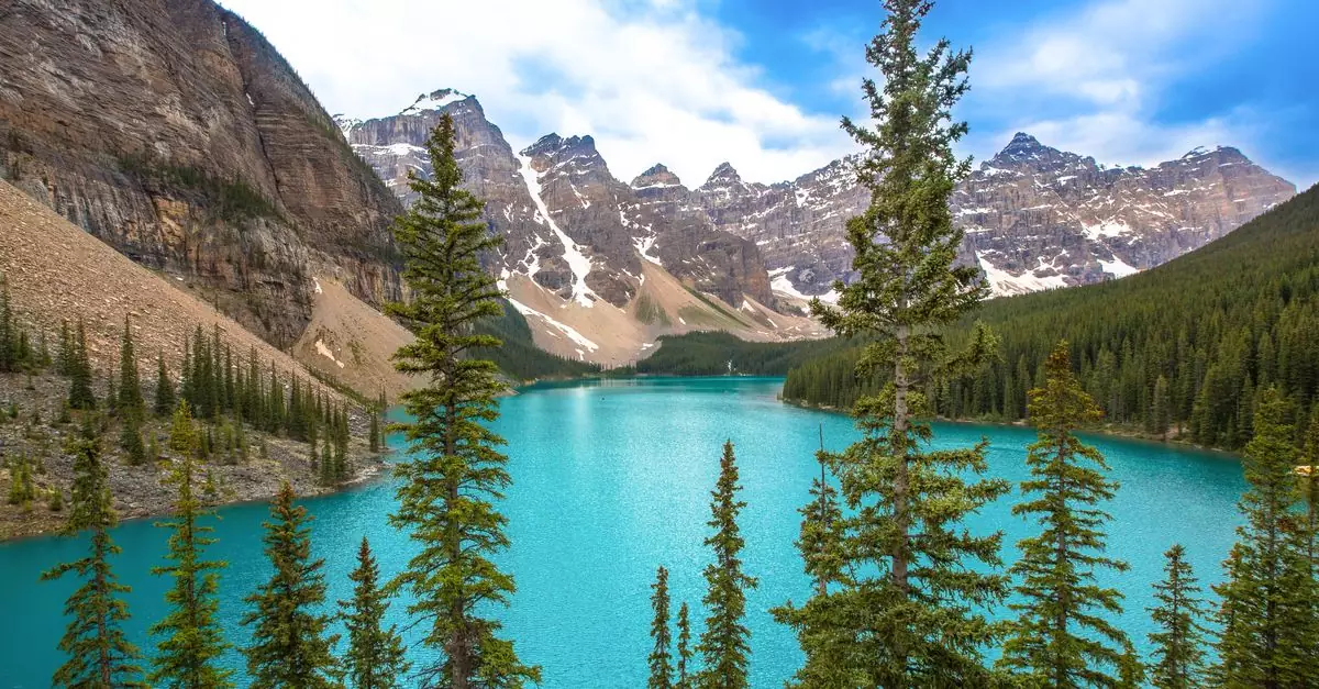 Breathtaking landscape of Moraine Lake with turquoise waters and surrounding mountains in Banff National Park, Canada.